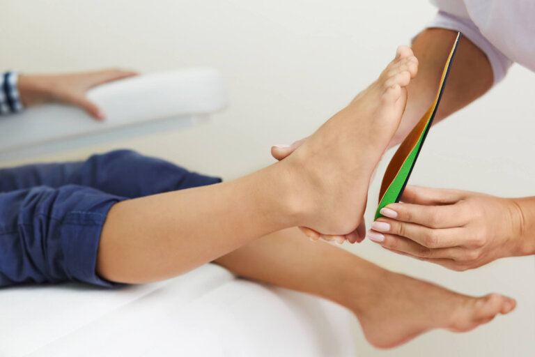 podiatrist examining patients foot