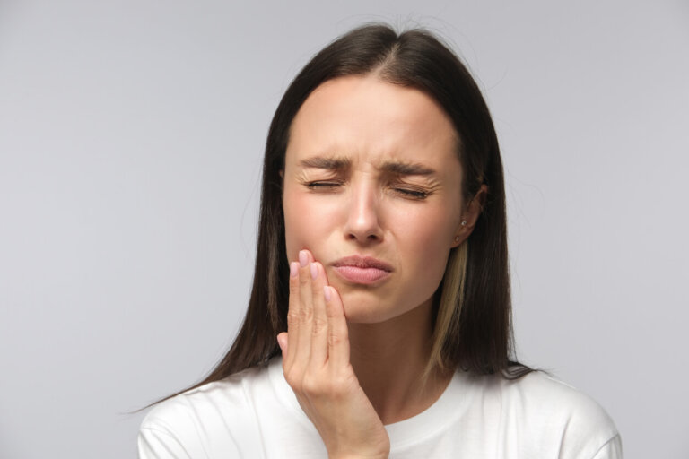 Woman suffering a toothache from dental malpractice.