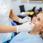 Older woman receiving treatment for tooth loss.