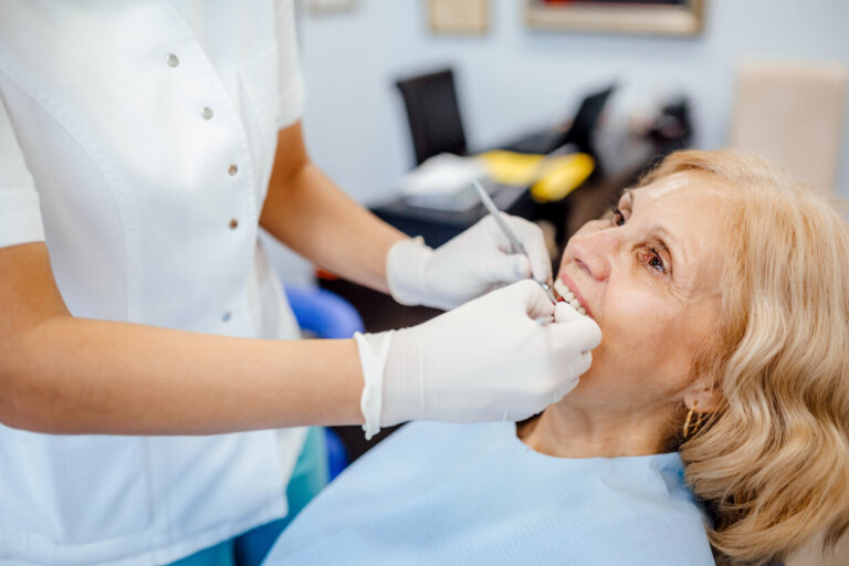 Older woman receiving treatment for tooth loss.