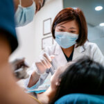 Female dentist working with patient.