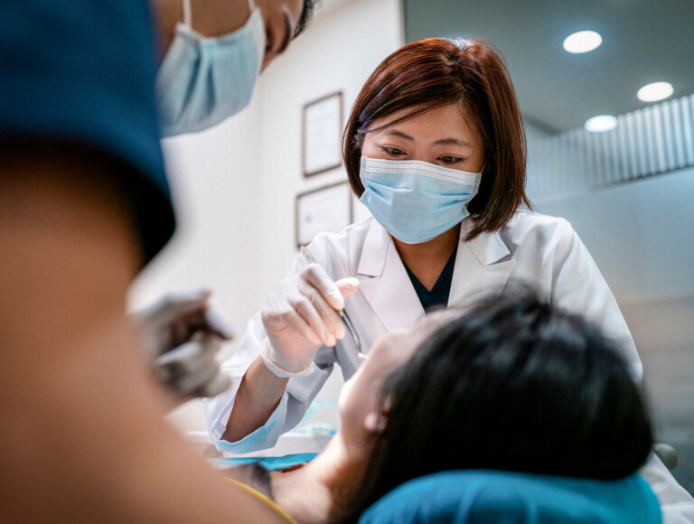Female dentist working with patient.