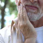 Older man with dental nerve pain.