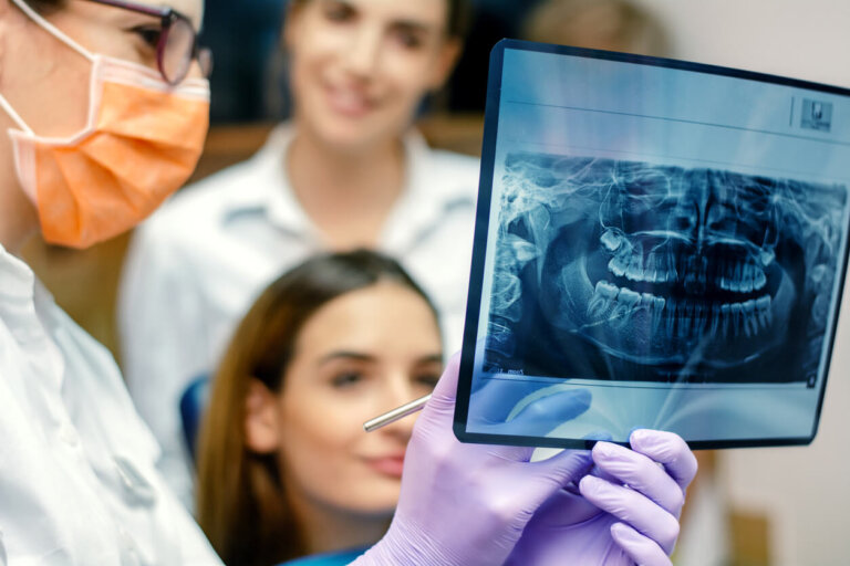 dentist holding up xray showing patient and mother