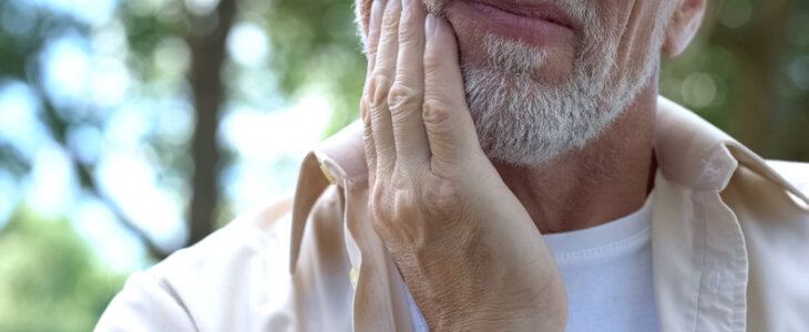 Senior man having problem with numb mouth after a surgery