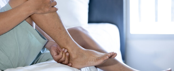 Middle aged man suffering from shin splints or medial tibial stress syndrome and achilles tendinitis,inflammation of muscle,acute pain in shin and leg caused by prolonged running,physical injury